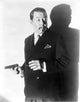 Warner Oland holding a gun photo print in multiple sizes.