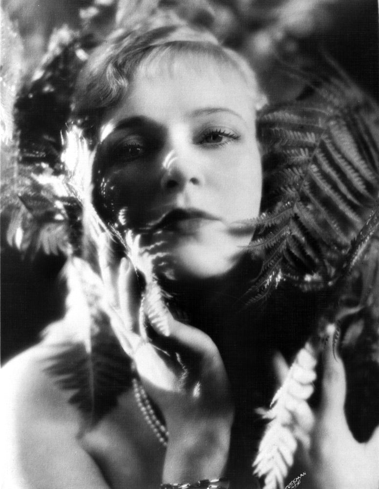 Close-up portrait of Olga Baclanova surrounded by leaves, photo print.