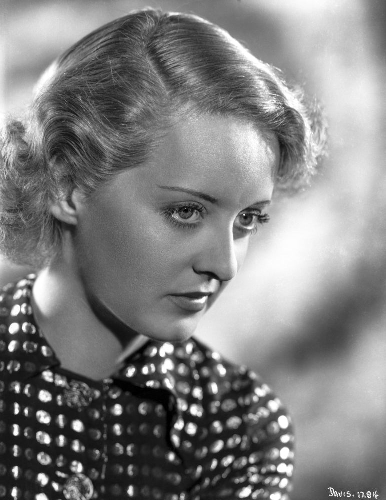 Bette Davis portrait photo print in a polka dot black shirt, looking slightly down.