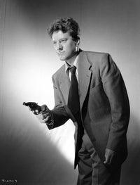 Michael O'Shea holding a gun photo print, available in multiple sizes.