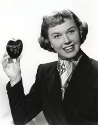 Classic photo print of Doris Day holding an apple.