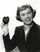 Classic photo print of Doris Day holding an apple.