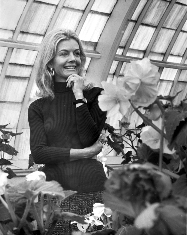 Joanna Barnes in a greenhouse photo print, vibrant and elegant.