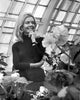 Joanna Barnes in a greenhouse photo print, vibrant and elegant.