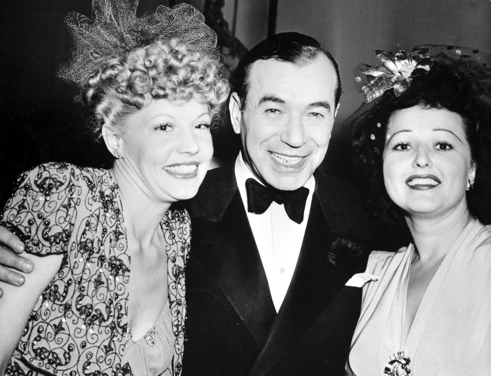 Harry Richman poses with women at a party photo print