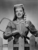 Judy Garland holding a tennis racket in a striped shirt photo print.
