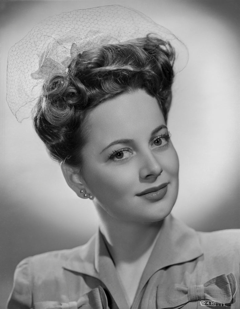Olivia DeHavilland portrait photo print in blouse with earrings.