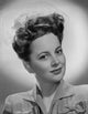 Olivia DeHavilland portrait photo print in blouse with earrings.