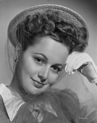 Olivia DeHavilland elegant portrait photo print with formal top, earrings, and gloves.