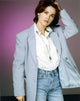 Kim Delaney posed in a gray coat photo print.