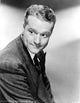 Black and white portrait photo print of Red Skelton looking away in a formal suit.