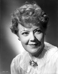 Close-up black and white portrait of Spring Byington in a white lace dress
