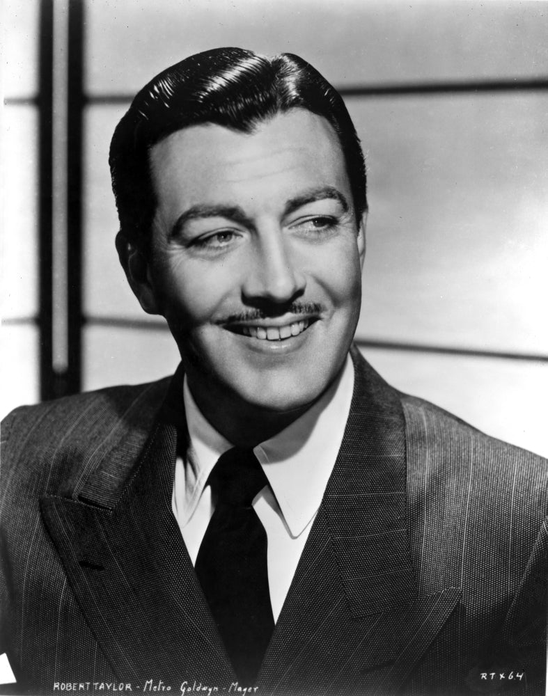 Robert Taylor Grinning in Suit Photo Print showcasing classic Hollywood charm.