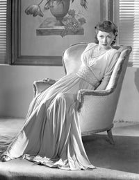 Gloria Grahame leaning on a chair in a white gown photo print