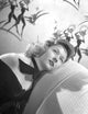 Gloria Grahame photo print lying on couch in black gown with curly hair