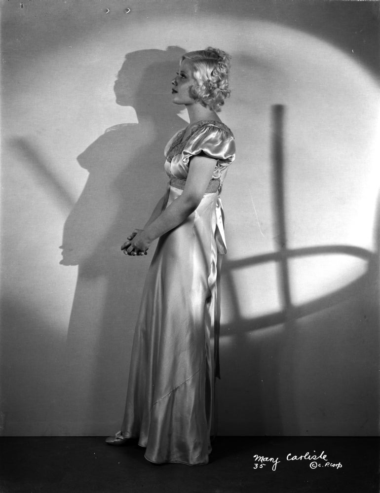 Mary Carlisle standing in shiny white dress photo print