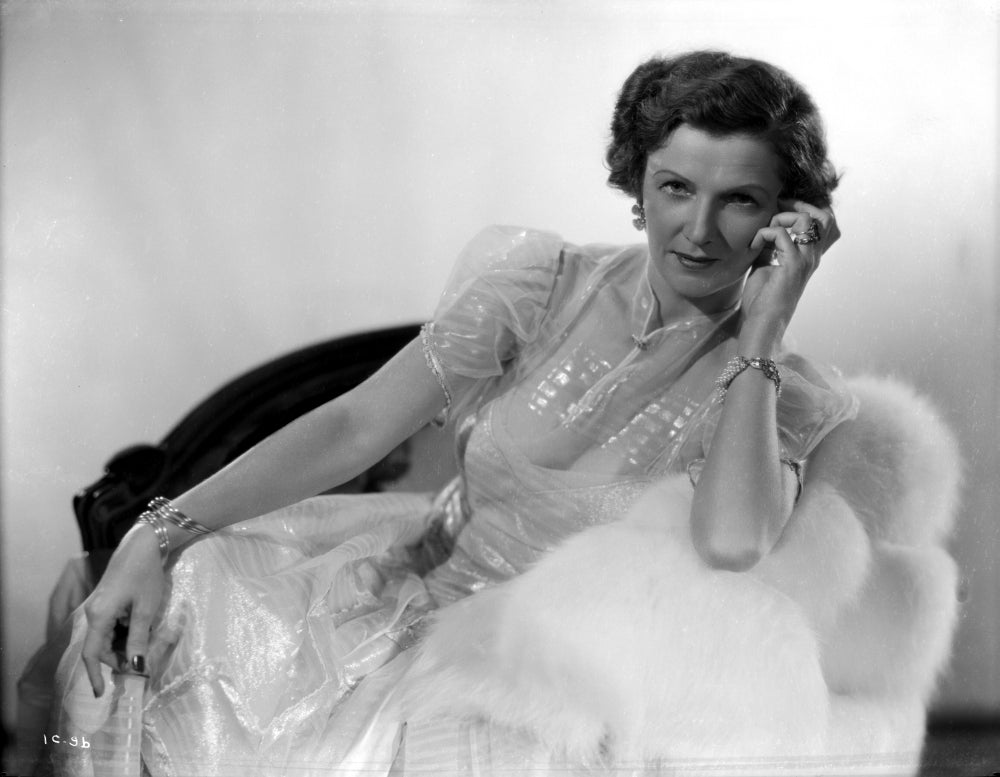 Irene Castle sitting and leaning on a couch in a gown, photo print.