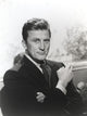 Kirk Douglas portrait photo print in black suit with cigarette.