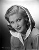 Joan Caulfield classic portrait photo print, wearing a hood.