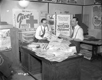 Two Men with a Pile of Newspapers Photo Print