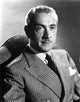 Clifton Webb sitting in tuxedo photo print
