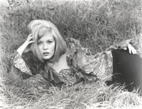 Faye Dunaway lying in classic photo print showcasing elegance and charisma.