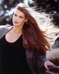 Photo print of Katie Haas posed in a black coat.