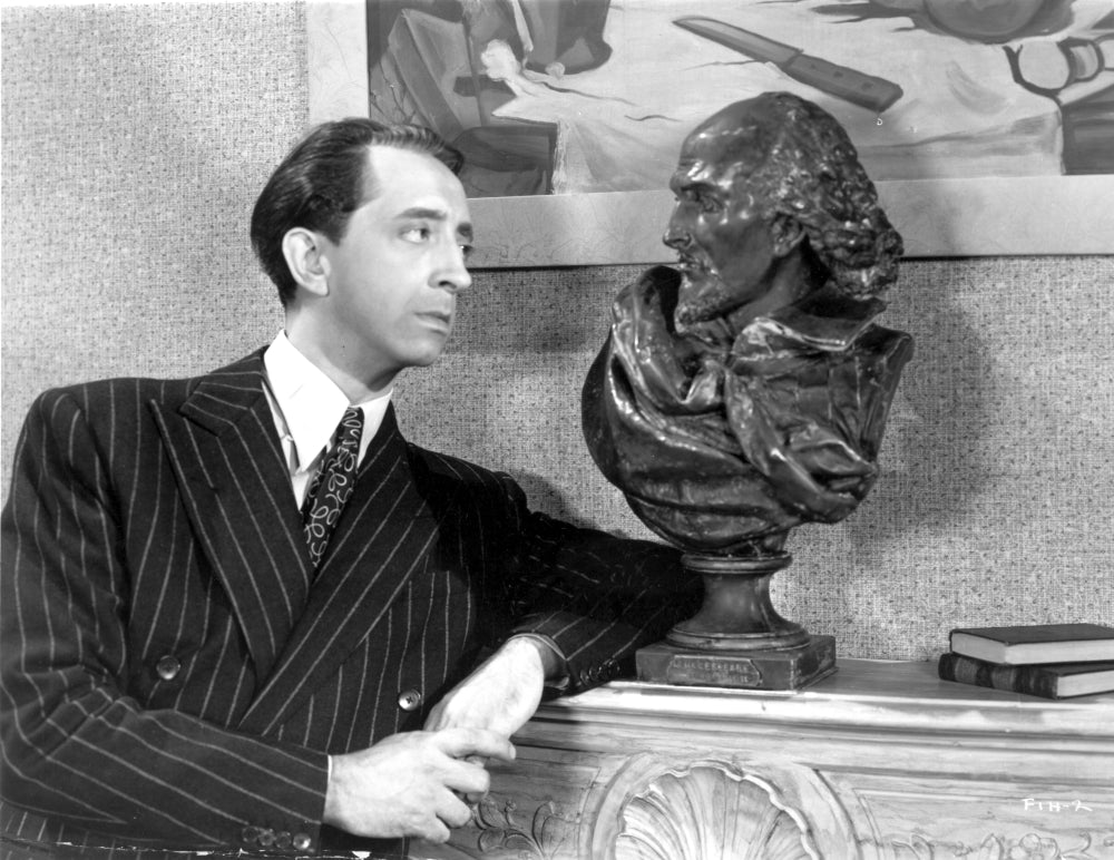 John Abbot posed in a suit photo print showcasing elegance