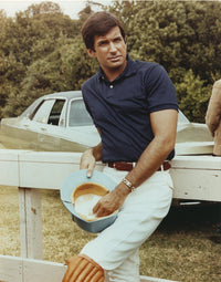 George Hamilton leaning on a white fence photo print