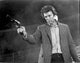Clint Eastwood holding a pistol in a classic movie scene photo print.