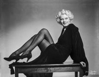 Jean Harlow reclining on a table in a black long sleeve dress - vintage Hollywood photo print.