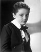 Freddie Bartholomew sitting on a chair with legs crossed photo print.