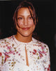 Jennifer Esposito smiling portrait photo print in a white dress.