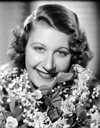 Joan Davis smiling surrounded by colorful flowers photo print.
