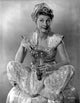 Black and white photo print of Joan Davis holding a lightbulb.
