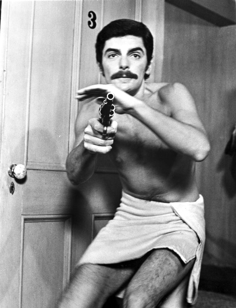 Photo print of Richard Benjamin holding a gun, capturing cinematic history.