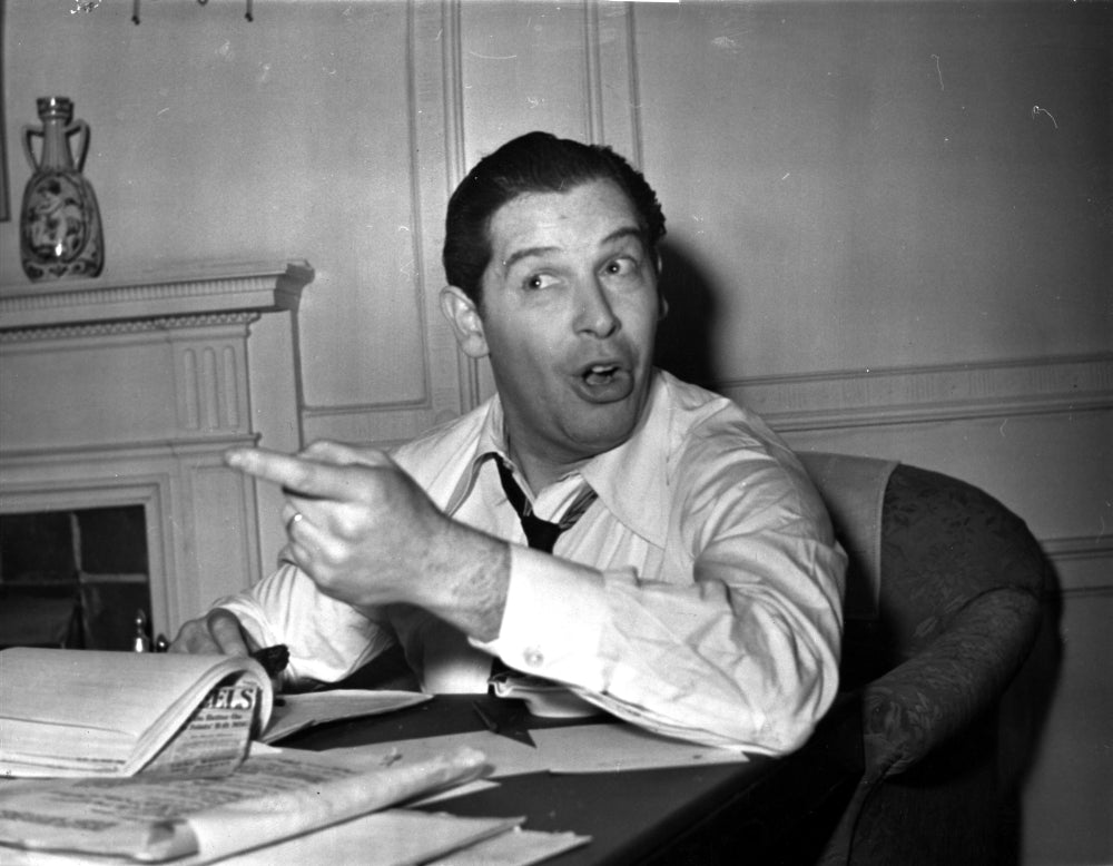 Milton Berle sitting at his desk - Photo Print