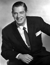 Milton Berle smiling in a black suit - classic photo print