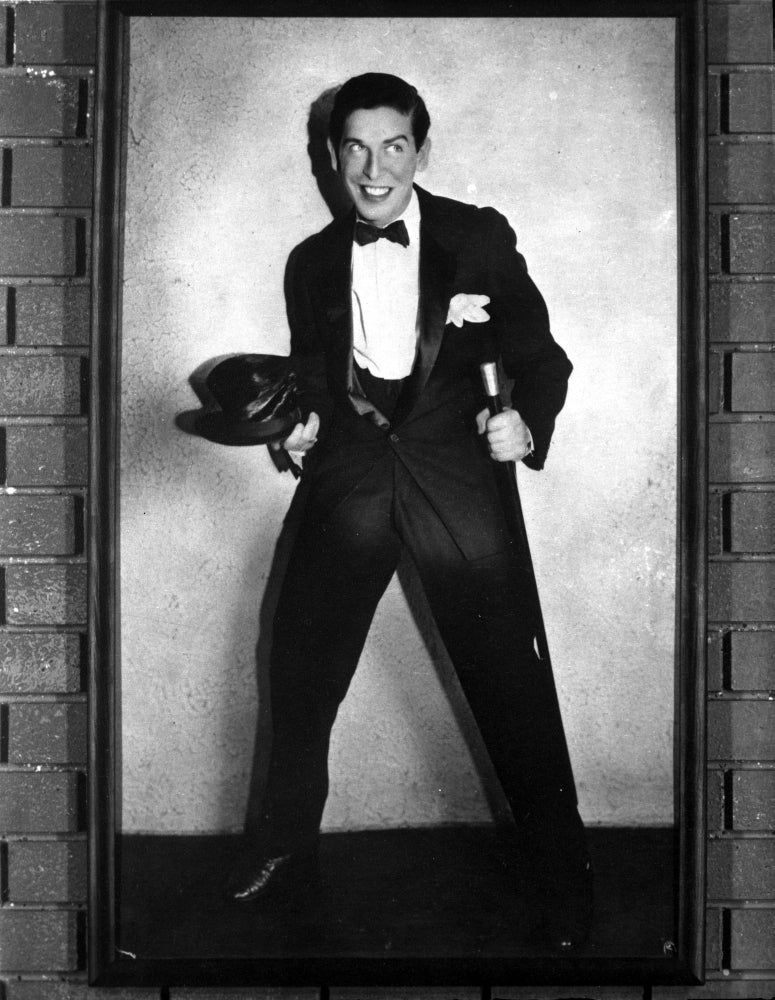 Milton Berle photo print in a black suit and cap, showcasing classic television style.