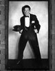 Milton Berle photo print in a black suit and cap, showcasing classic television style.