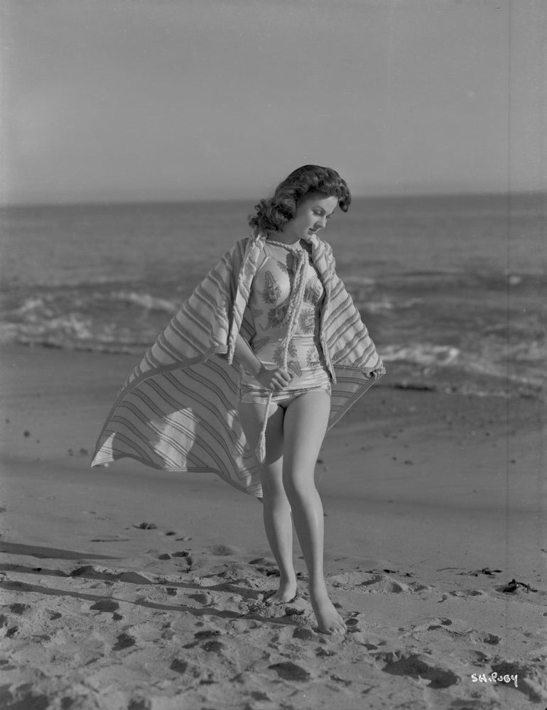 Susan Hayward posed in a colorful swimming suit photo print
