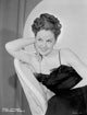 Susan Hayward sitting in a black dress photo print