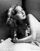 Susan Hayward Lying on a Bed Photo Print showcasing classic Hollywood elegance.