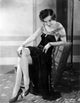 Fifi Dorsay seated on chair in elegant dress photo print