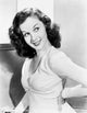 Susan Hayward photo print in a white dress with hands on waist.