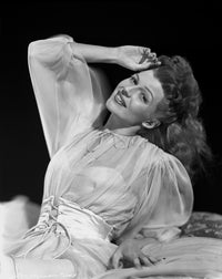 Rita Hayworth smiling in a see-through blouse photo print, classic Hollywood glamour.
