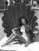 Rita Hayworth posed elegantly with a big shell photo print.