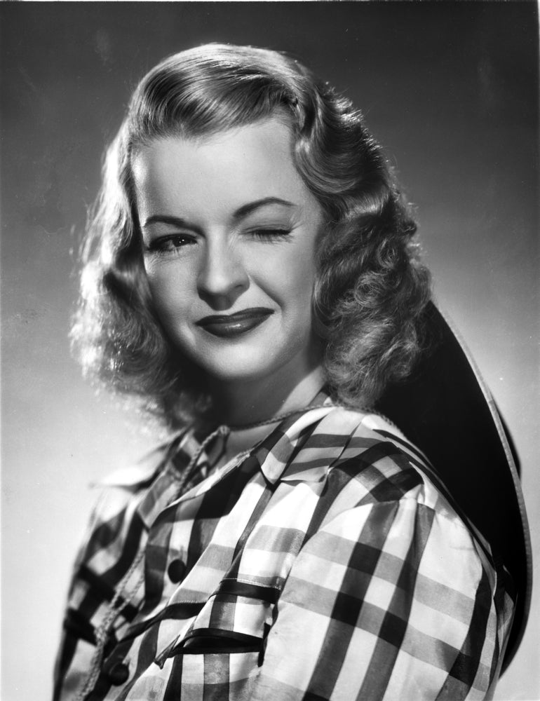 Dale Evans Winking Eye Portrait Photo Print featuring checkered background.