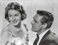 Indiscreet Couple Photo Print featuring a lady in a printed dress and a man in a suit.