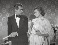 Indiscreet photo print of a man and woman facing each other.